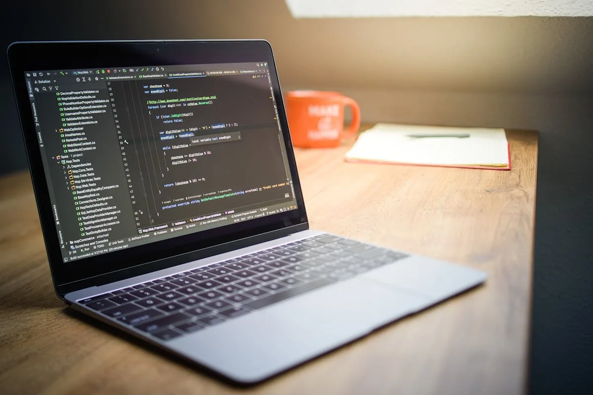 Developer workspace with laptop and code on screen